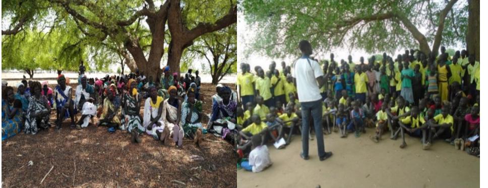 Community members and schoolchildren gathered under trees for awareness sessions